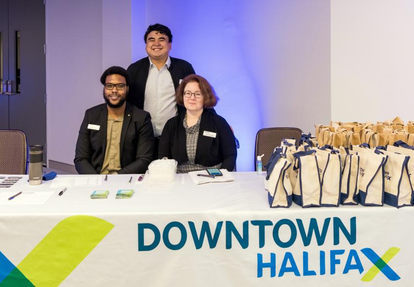 3 people at a registration table 