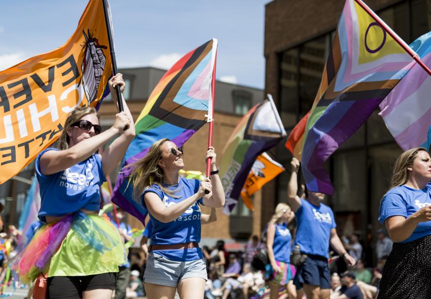 A parade with people waving flags