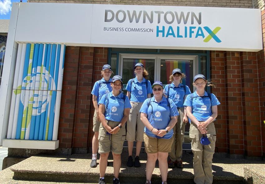 A group of people standing outside an office