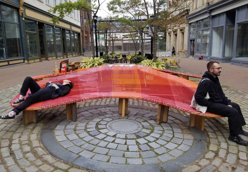 Two people sitting on The Blooming Seating