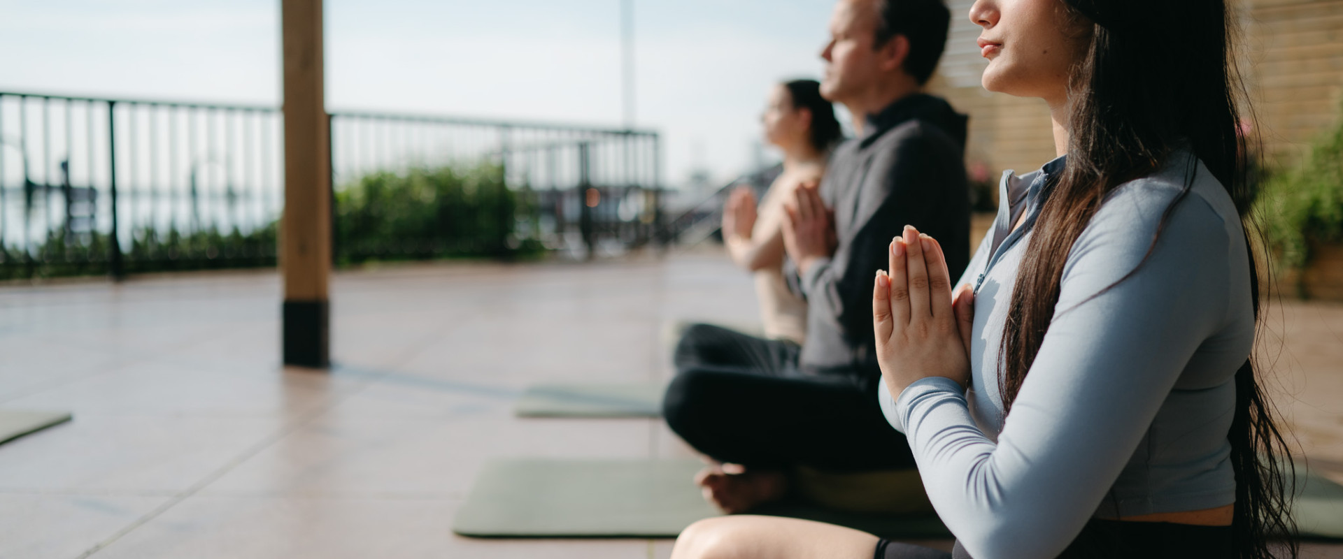 Attendees practicing meditation on Sable Patio at sunrise, overlooking the Halifax harbour