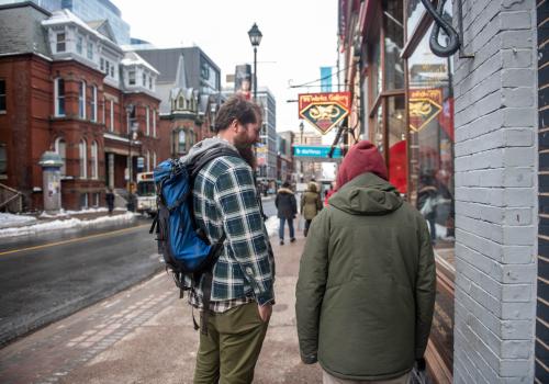 Two men walking down a street