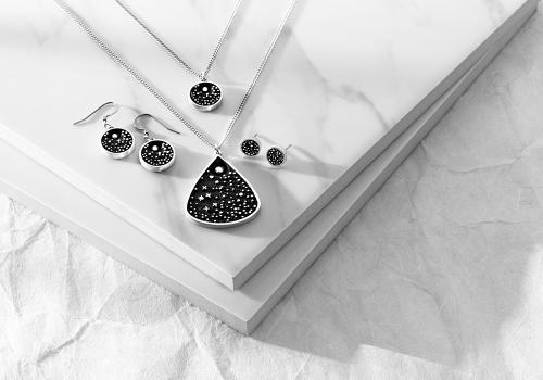 Photo of Amos Pewter jewelry on marble