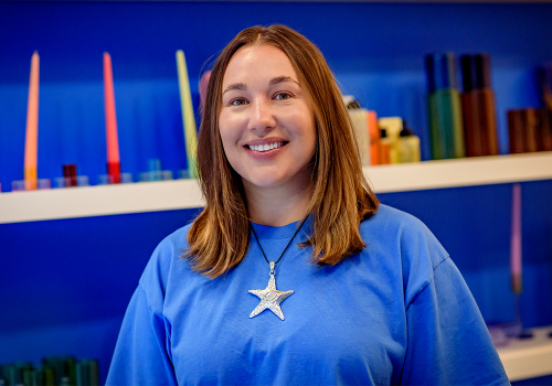 Alex Boudreau, owner of Pop By The Store smiling in her store