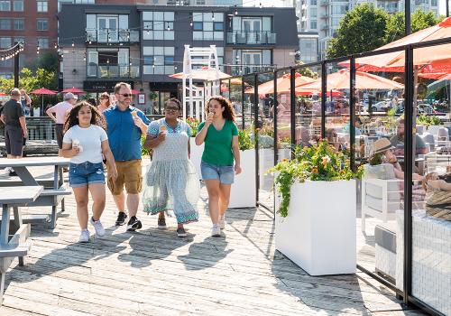 A family walks along the Halifax Waterfront during July in Downtown Halifax. 