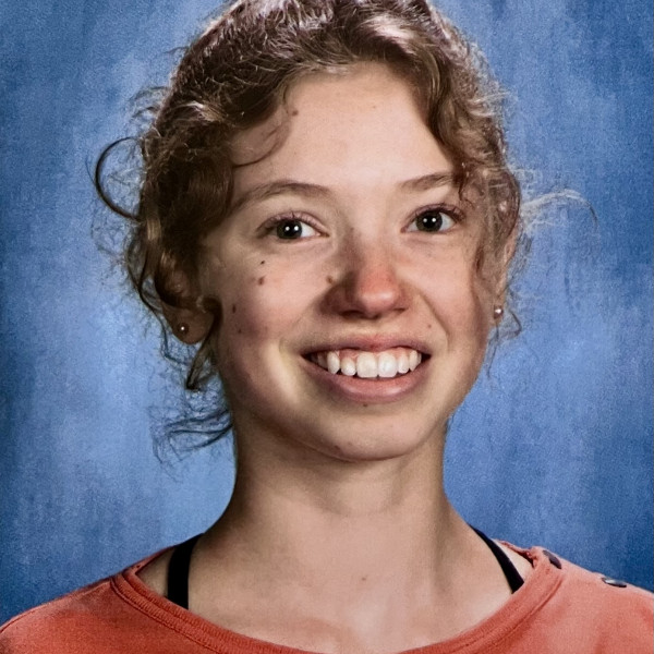 Smiling girl in orange shirt